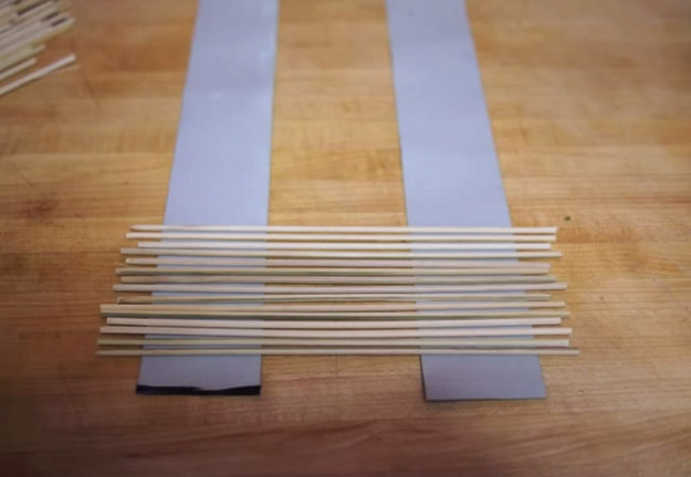 You can make your own your own sushi-rolling mat using wooden kabob sticks and duct tape.